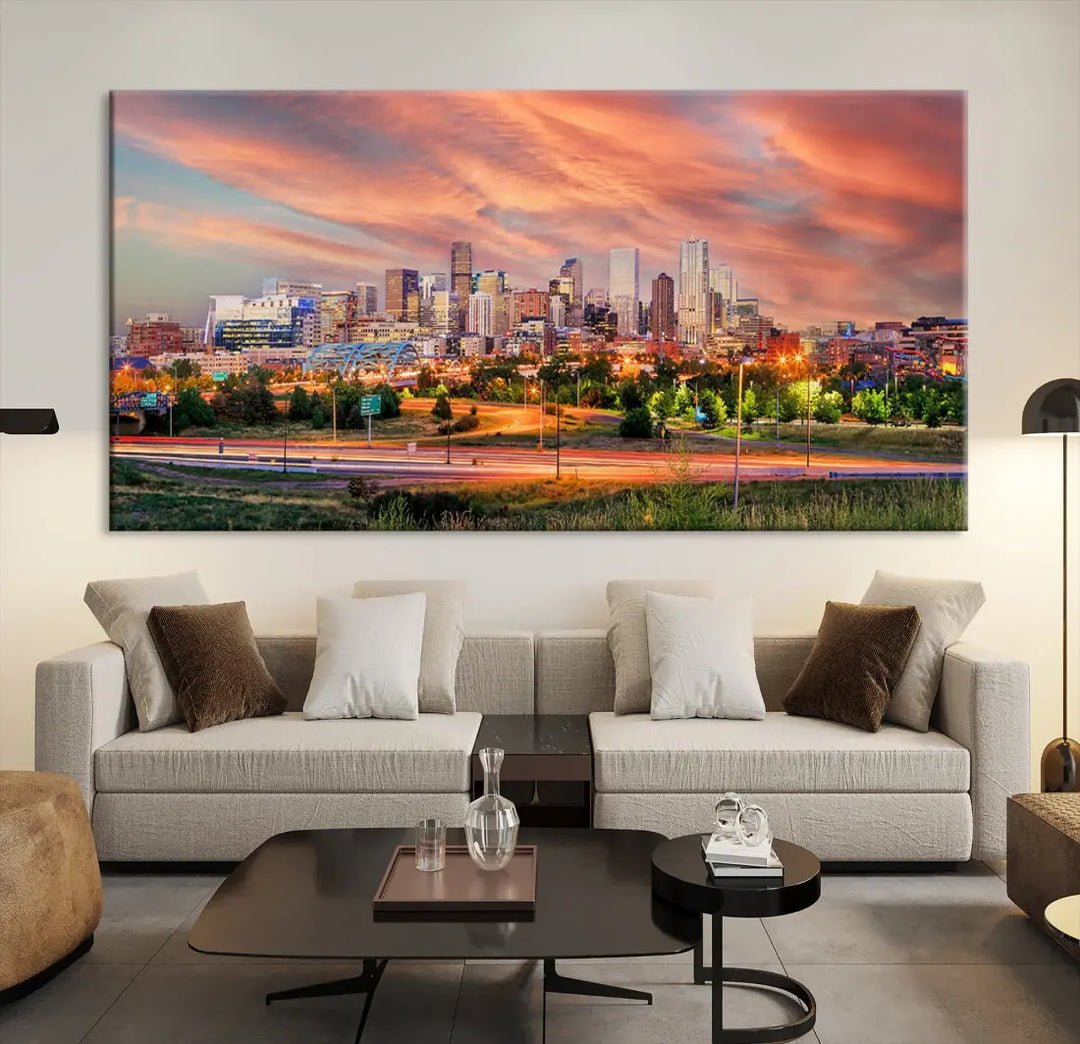 The modern living room showcases the "Denver City Lights Sunset Orange Cloudy Skyline Cityscape View Wall Art Canvas Print," a triptych of museum-quality canvases depicting a city skyline at sunset. This ready-to-hang artwork boasts a UV-protective coating to ensure lasting vibrancy.