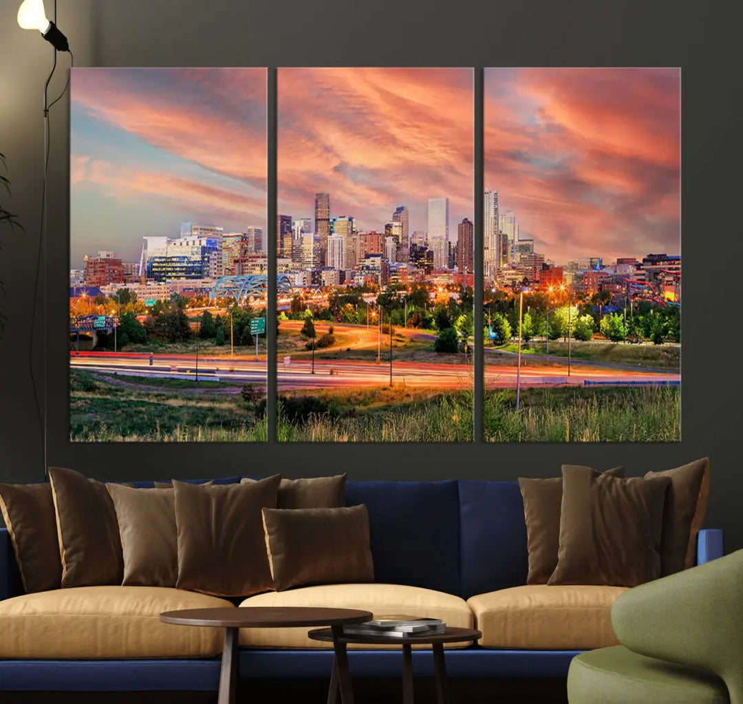 The modern living room showcases the "Denver City Lights Sunset Orange Cloudy Skyline Cityscape View Wall Art Canvas Print," a triptych of museum-quality canvases depicting a city skyline at sunset. This ready-to-hang artwork boasts a UV-protective coating to ensure lasting vibrancy.