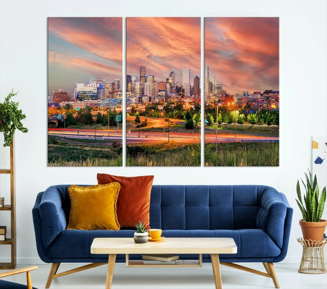 The modern living room showcases the "Denver City Lights Sunset Orange Cloudy Skyline Cityscape View Wall Art Canvas Print," a triptych of museum-quality canvases depicting a city skyline at sunset. This ready-to-hang artwork boasts a UV-protective coating to ensure lasting vibrancy.