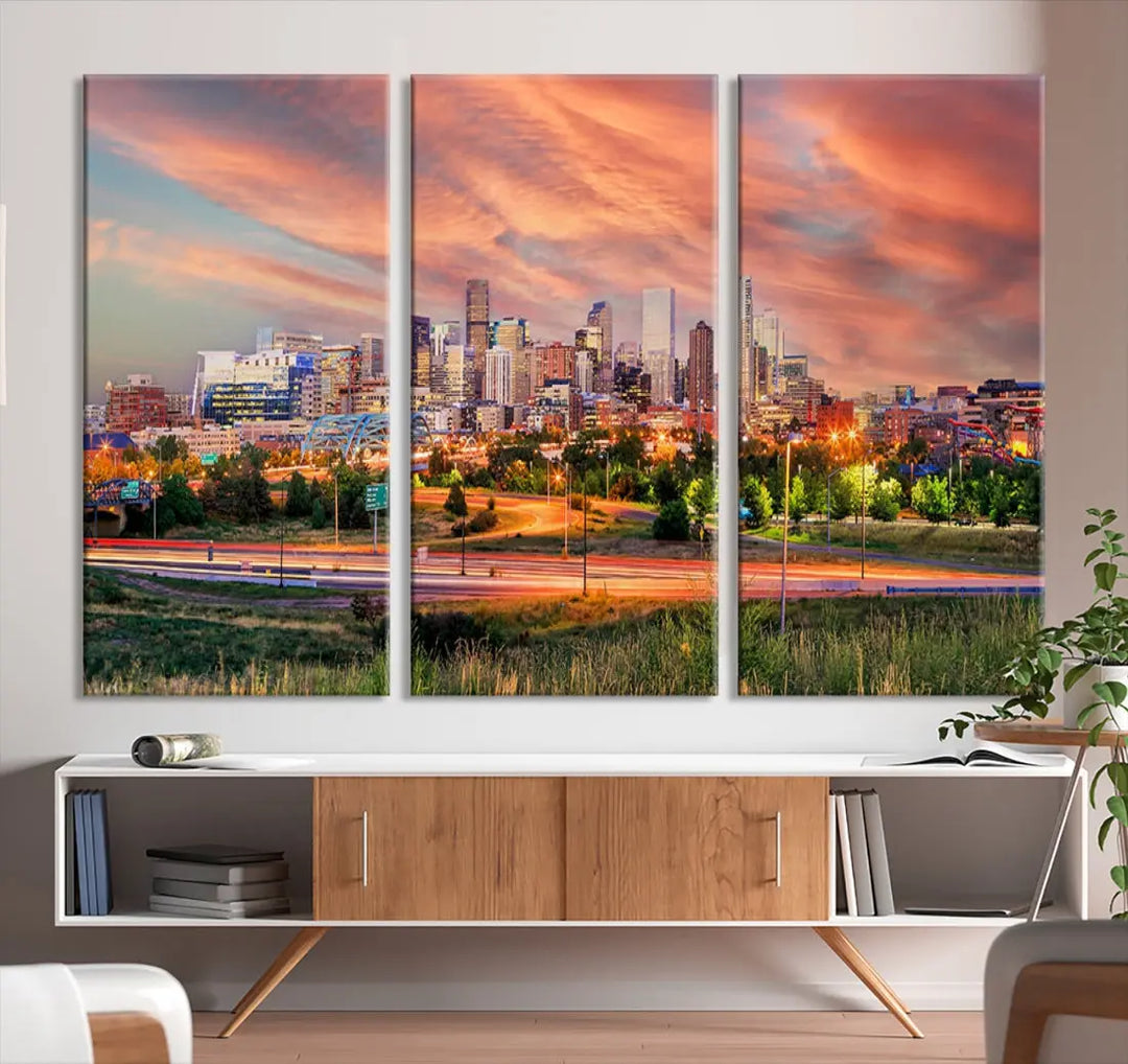 The modern living room showcases the "Denver City Lights Sunset Orange Cloudy Skyline Cityscape View Wall Art Canvas Print," a triptych of museum-quality canvases depicting a city skyline at sunset. This ready-to-hang artwork boasts a UV-protective coating to ensure lasting vibrancy.