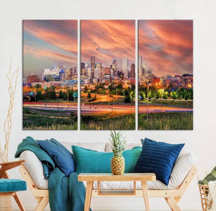 The modern living room showcases the "Denver City Lights Sunset Orange Cloudy Skyline Cityscape View Wall Art Canvas Print," a triptych of museum-quality canvases depicting a city skyline at sunset. This ready-to-hang artwork boasts a UV-protective coating to ensure lasting vibrancy.