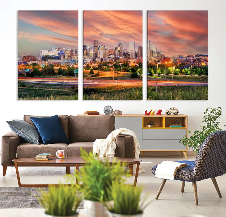 The modern living room showcases the "Denver City Lights Sunset Orange Cloudy Skyline Cityscape View Wall Art Canvas Print," a triptych of museum-quality canvases depicting a city skyline at sunset. This ready-to-hang artwork boasts a UV-protective coating to ensure lasting vibrancy.