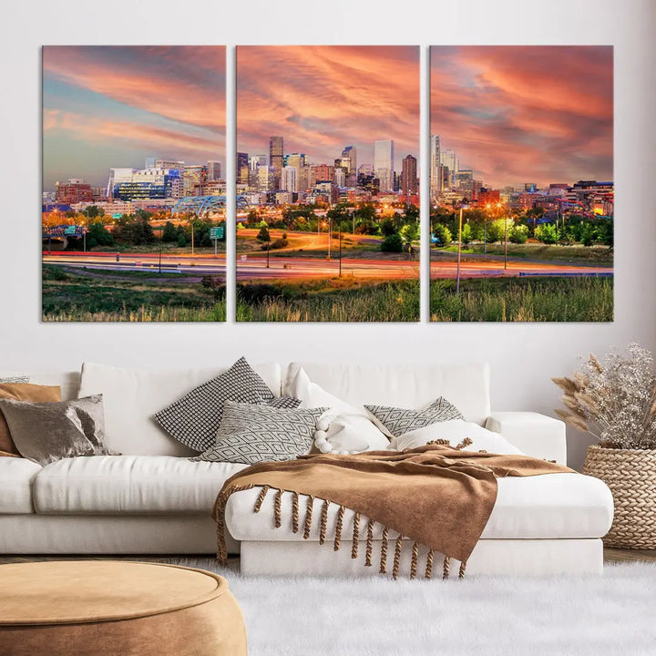 The modern living room showcases the "Denver City Lights Sunset Orange Cloudy Skyline Cityscape View Wall Art Canvas Print," a triptych of museum-quality canvases depicting a city skyline at sunset. This ready-to-hang artwork boasts a UV-protective coating to ensure lasting vibrancy.