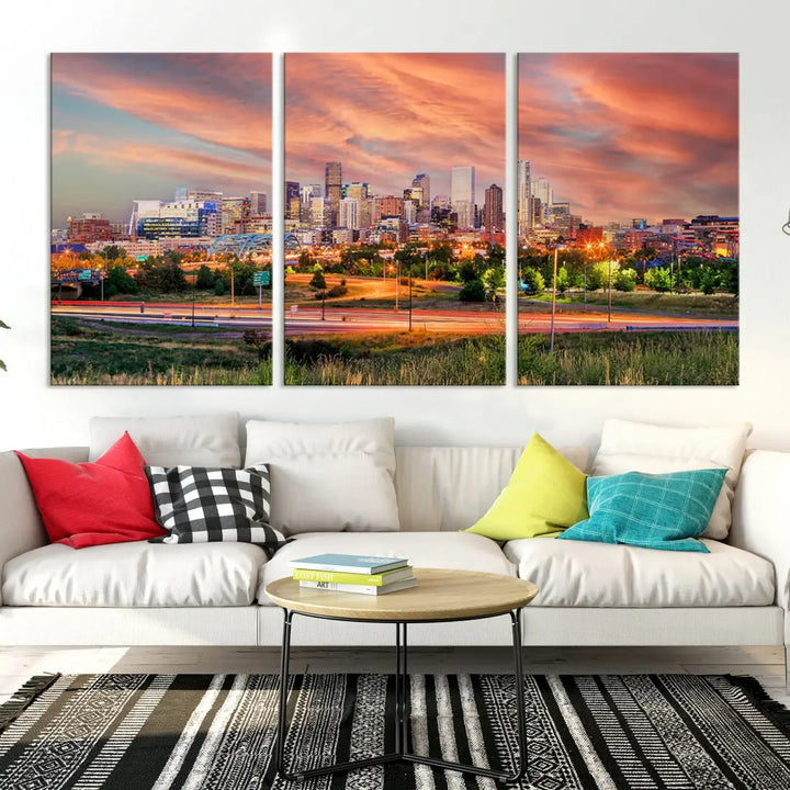 The modern living room showcases the "Denver City Lights Sunset Orange Cloudy Skyline Cityscape View Wall Art Canvas Print," a triptych of museum-quality canvases depicting a city skyline at sunset. This ready-to-hang artwork boasts a UV-protective coating to ensure lasting vibrancy.