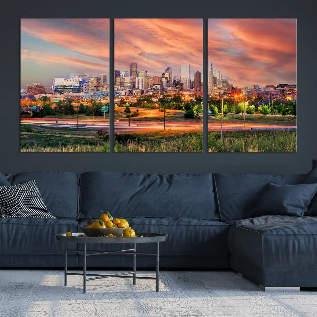 The modern living room showcases the "Denver City Lights Sunset Orange Cloudy Skyline Cityscape View Wall Art Canvas Print," a triptych of museum-quality canvases depicting a city skyline at sunset. This ready-to-hang artwork boasts a UV-protective coating to ensure lasting vibrancy.