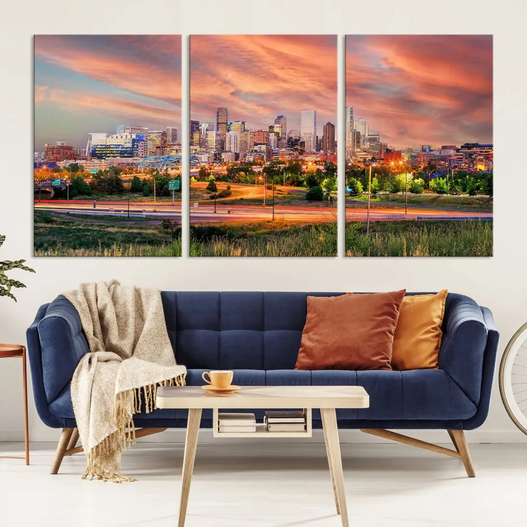 The modern living room showcases the "Denver City Lights Sunset Orange Cloudy Skyline Cityscape View Wall Art Canvas Print," a triptych of museum-quality canvases depicting a city skyline at sunset. This ready-to-hang artwork boasts a UV-protective coating to ensure lasting vibrancy.