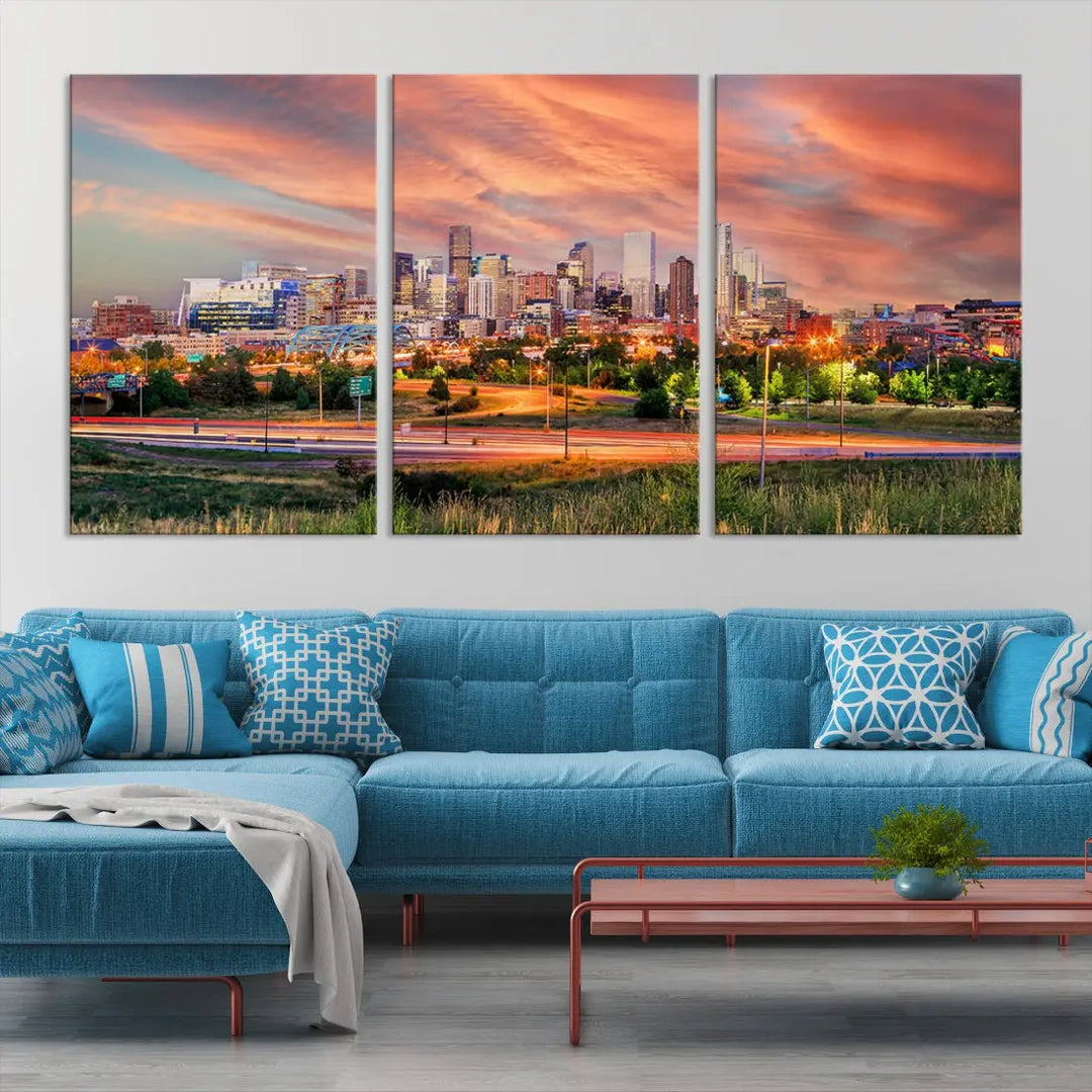 The modern living room showcases the "Denver City Lights Sunset Orange Cloudy Skyline Cityscape View Wall Art Canvas Print," a triptych of museum-quality canvases depicting a city skyline at sunset. This ready-to-hang artwork boasts a UV-protective coating to ensure lasting vibrancy.