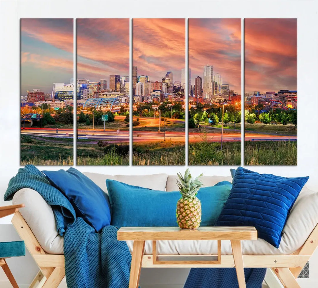 The modern living room showcases the "Denver City Lights Sunset Orange Cloudy Skyline Cityscape View Wall Art Canvas Print," a triptych of museum-quality canvases depicting a city skyline at sunset. This ready-to-hang artwork boasts a UV-protective coating to ensure lasting vibrancy.