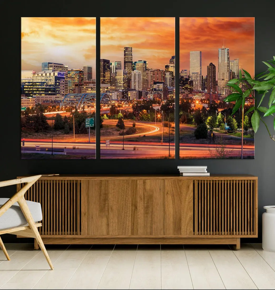 The Denver City Lights Sunset Orange Skyline Cityscape View Wall Art Canvas Print features a vibrant city skyline at sunset with orange and yellow skies. Crafted on museum-quality canvas with a UV-protective coating, it showcases the artistry of a professional craftsman.