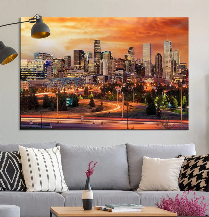 The Denver City Lights Sunset Orange Skyline Cityscape View Wall Art Canvas Print features a vibrant city skyline at sunset with orange and yellow skies. Crafted on museum-quality canvas with a UV-protective coating, it showcases the artistry of a professional craftsman.