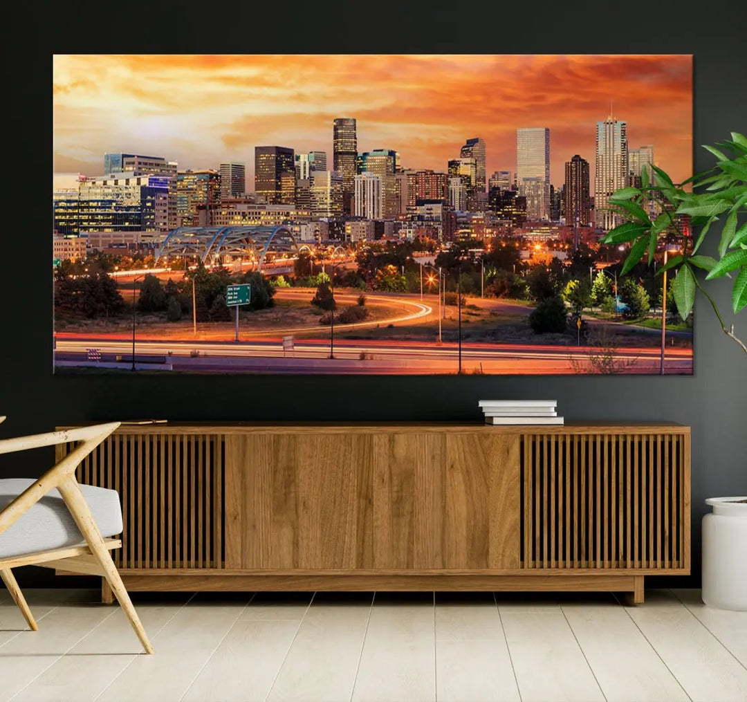 The Denver City Lights Sunset Orange Skyline Cityscape View Wall Art Canvas Print features a vibrant city skyline at sunset with orange and yellow skies. Crafted on museum-quality canvas with a UV-protective coating, it showcases the artistry of a professional craftsman.