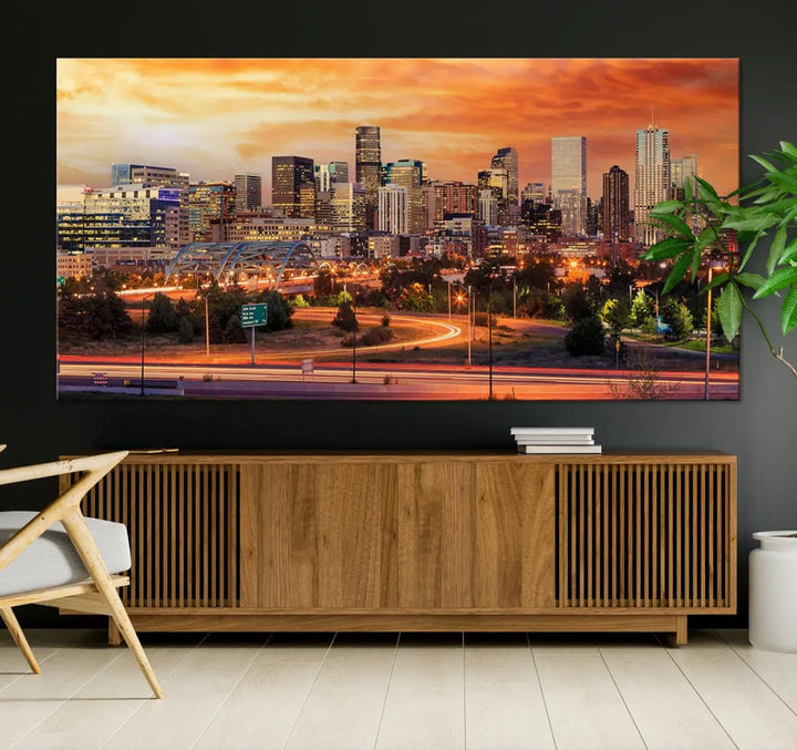 The Denver City Lights Sunset Orange Skyline Cityscape View Wall Art Canvas Print features a vibrant city skyline at sunset with orange and yellow skies. Crafted on museum-quality canvas with a UV-protective coating, it showcases the artistry of a professional craftsman.