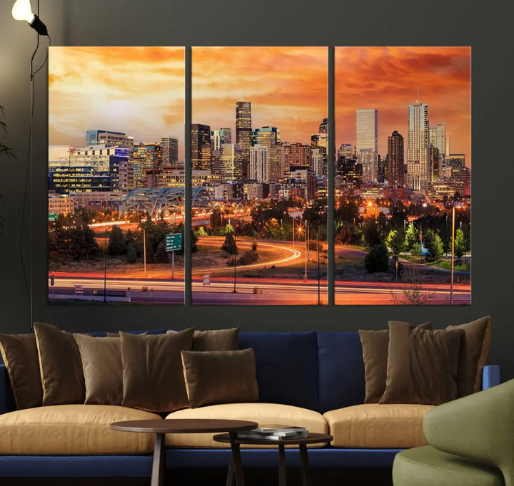 The Denver City Lights Sunset Orange Skyline Cityscape View Wall Art Canvas Print features a vibrant city skyline at sunset with orange and yellow skies. Crafted on museum-quality canvas with a UV-protective coating, it showcases the artistry of a professional craftsman.