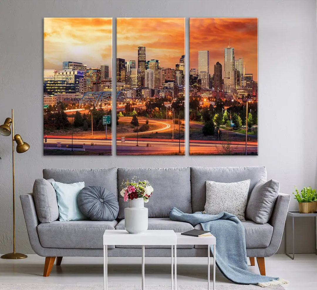 The Denver City Lights Sunset Orange Skyline Cityscape View Wall Art Canvas Print features a vibrant city skyline at sunset with orange and yellow skies. Crafted on museum-quality canvas with a UV-protective coating, it showcases the artistry of a professional craftsman.