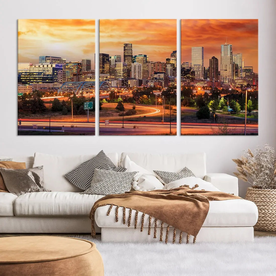 The Denver City Lights Sunset Orange Skyline Cityscape View Wall Art Canvas Print features a vibrant city skyline at sunset with orange and yellow skies. Crafted on museum-quality canvas with a UV-protective coating, it showcases the artistry of a professional craftsman.