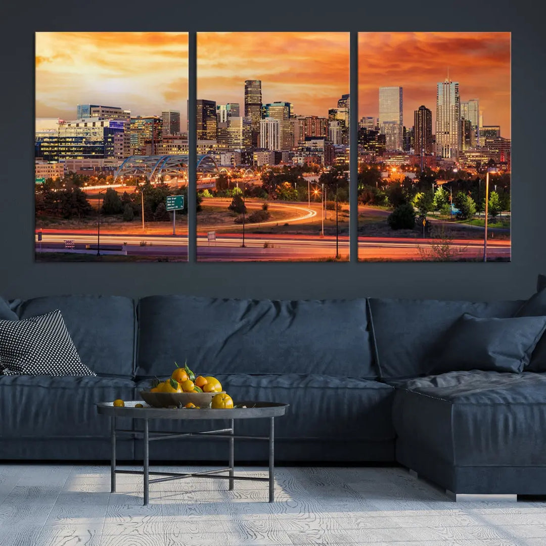 The Denver City Lights Sunset Orange Skyline Cityscape View Wall Art Canvas Print features a vibrant city skyline at sunset with orange and yellow skies. Crafted on museum-quality canvas with a UV-protective coating, it showcases the artistry of a professional craftsman.