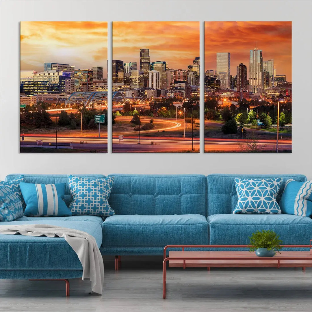 The Denver City Lights Sunset Orange Skyline Cityscape View Wall Art Canvas Print features a vibrant city skyline at sunset with orange and yellow skies. Crafted on museum-quality canvas with a UV-protective coating, it showcases the artistry of a professional craftsman.