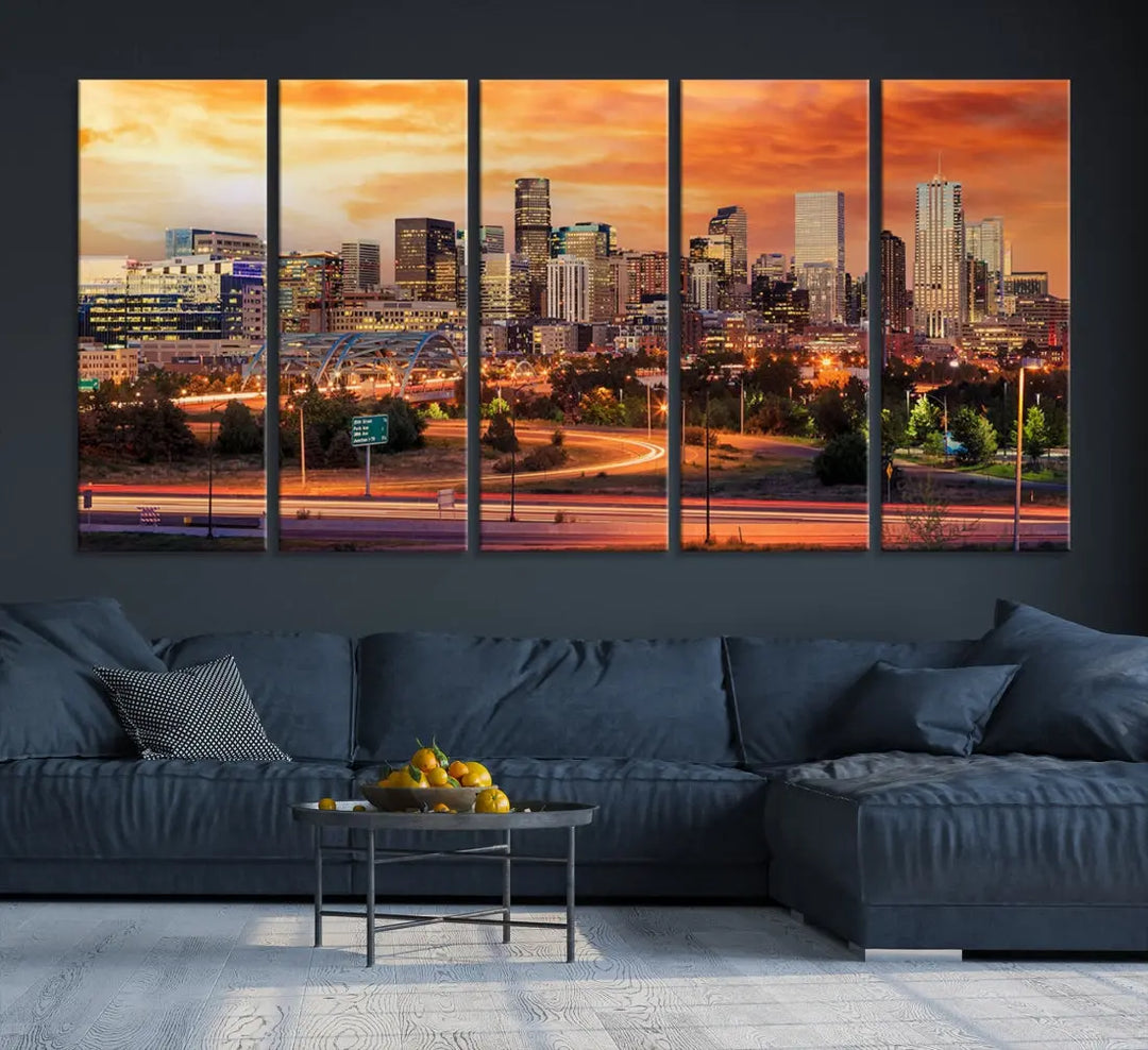 The Denver City Lights Sunset Orange Skyline Cityscape View Wall Art Canvas Print features a vibrant city skyline at sunset with orange and yellow skies. Crafted on museum-quality canvas with a UV-protective coating, it showcases the artistry of a professional craftsman.