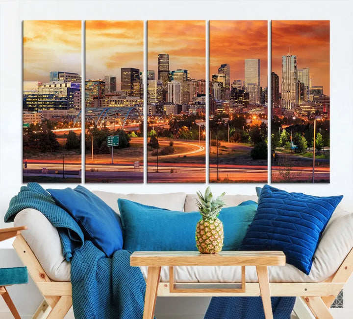 The Denver City Lights Sunset Orange Skyline Cityscape View Wall Art Canvas Print features a vibrant city skyline at sunset with orange and yellow skies. Crafted on museum-quality canvas with a UV-protective coating, it showcases the artistry of a professional craftsman.