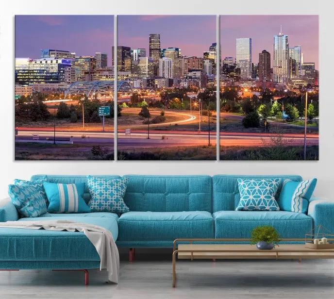 The cozy living room is adorned with a triptych of the "Denver City Lights Sunset Purple Skyline Cityscape View Wall Art Canvas Print." Professionally hand-assembled, these museum-quality canvases bring elegance and sophistication to the space, complemented by the convenience of free shipping.