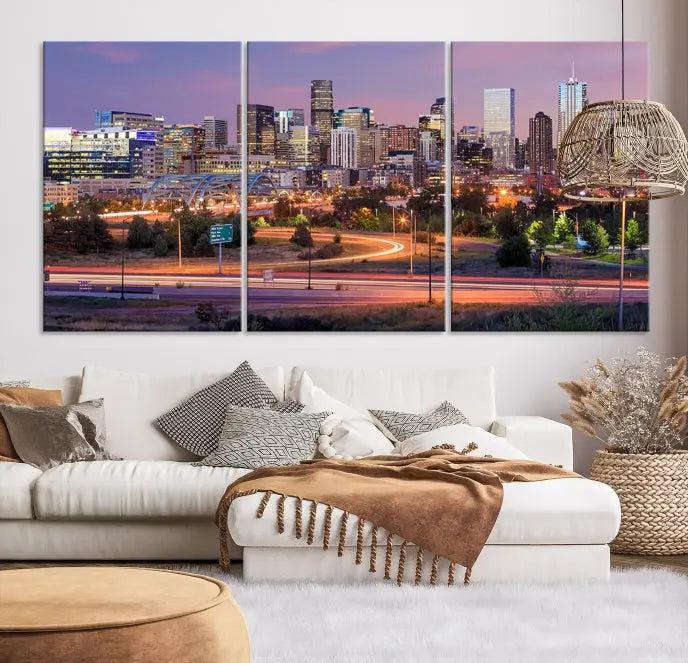 The cozy living room is adorned with a triptych of the "Denver City Lights Sunset Purple Skyline Cityscape View Wall Art Canvas Print." Professionally hand-assembled, these museum-quality canvases bring elegance and sophistication to the space, complemented by the convenience of free shipping.