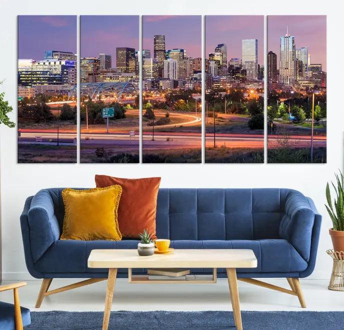 The cozy living room is adorned with a triptych of the "Denver City Lights Sunset Purple Skyline Cityscape View Wall Art Canvas Print." Professionally hand-assembled, these museum-quality canvases bring elegance and sophistication to the space, complemented by the convenience of free shipping.