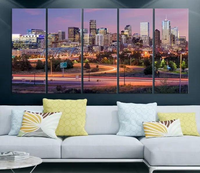 The cozy living room is adorned with a triptych of the "Denver City Lights Sunset Purple Skyline Cityscape View Wall Art Canvas Print." Professionally hand-assembled, these museum-quality canvases bring elegance and sophistication to the space, complemented by the convenience of free shipping.