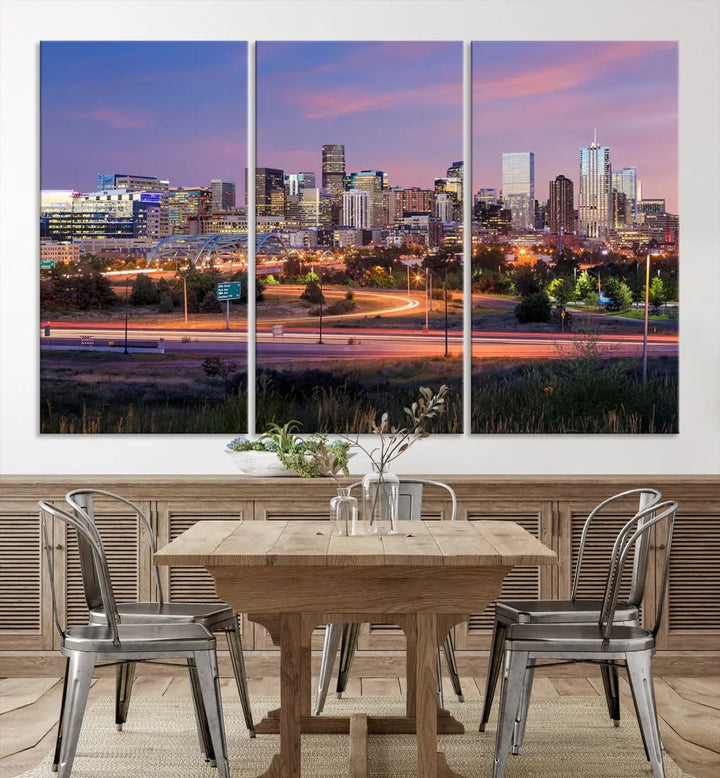 The Denver City Lights Sunset Purple Skyline Cityscape View Wall Art Canvas Print is crafted on museum-quality canvas with a UV-protective coating. It is displayed on a wall.