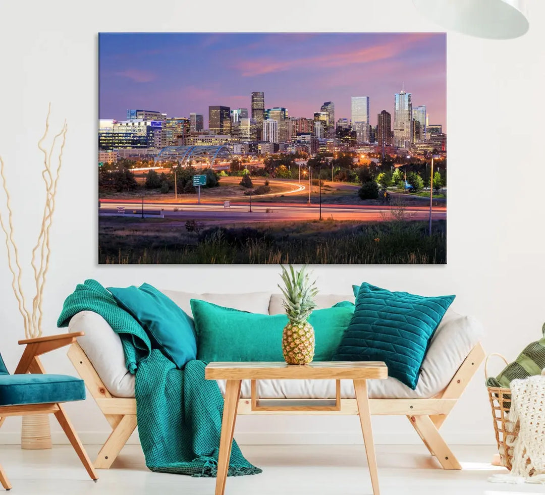 The Denver City Lights Sunset Purple Skyline Cityscape View Wall Art Canvas Print is crafted on museum-quality canvas with a UV-protective coating. It is displayed on a wall.