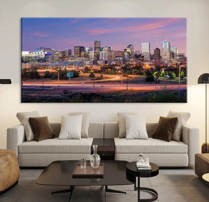 The Denver City Lights Sunset Purple Skyline Cityscape View Wall Art Canvas Print is crafted on museum-quality canvas with a UV-protective coating. It is displayed on a wall.