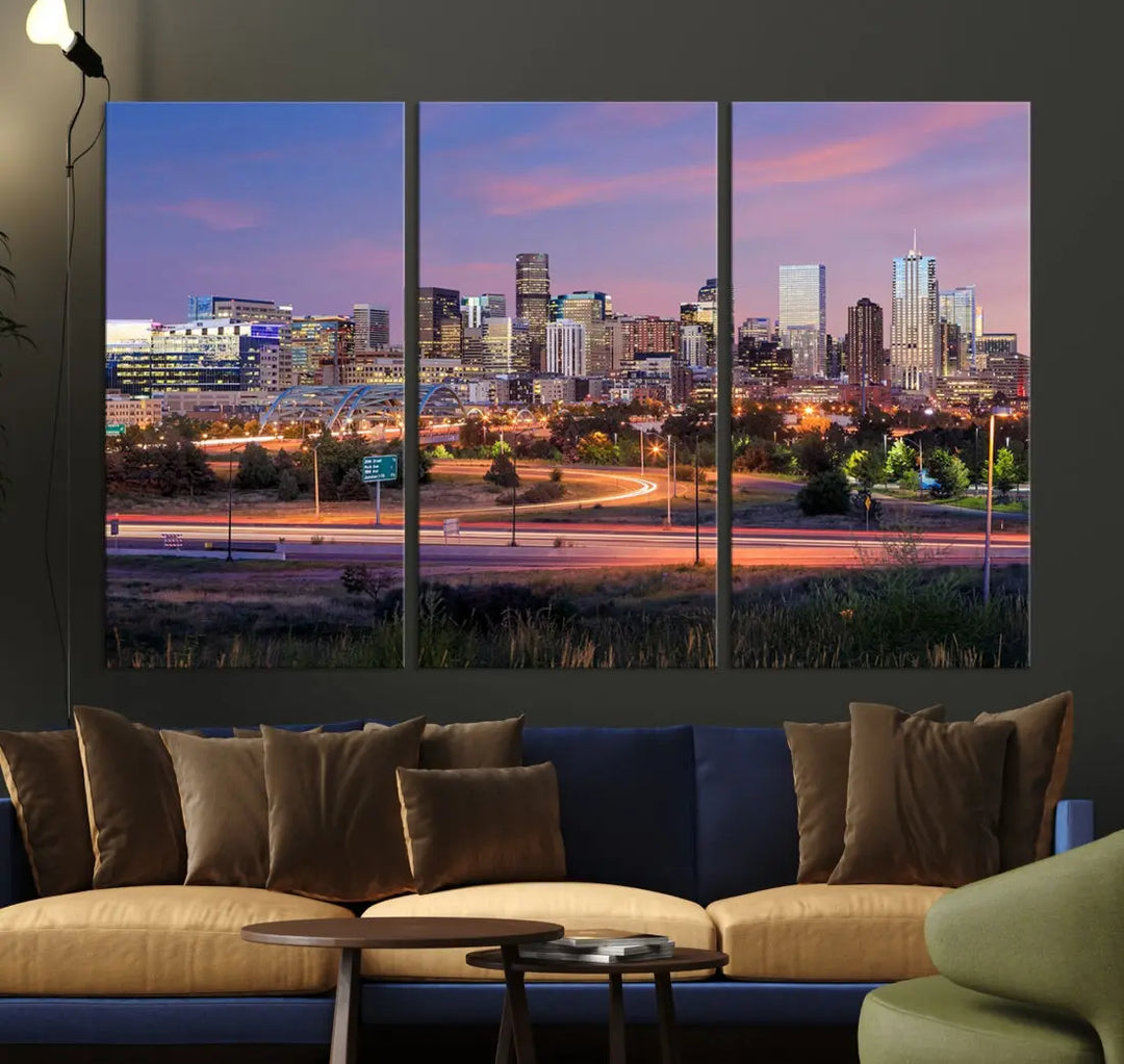 The Denver City Lights Sunset Purple Skyline Cityscape View Wall Art Canvas Print is crafted on museum-quality canvas with a UV-protective coating. It is displayed on a wall.