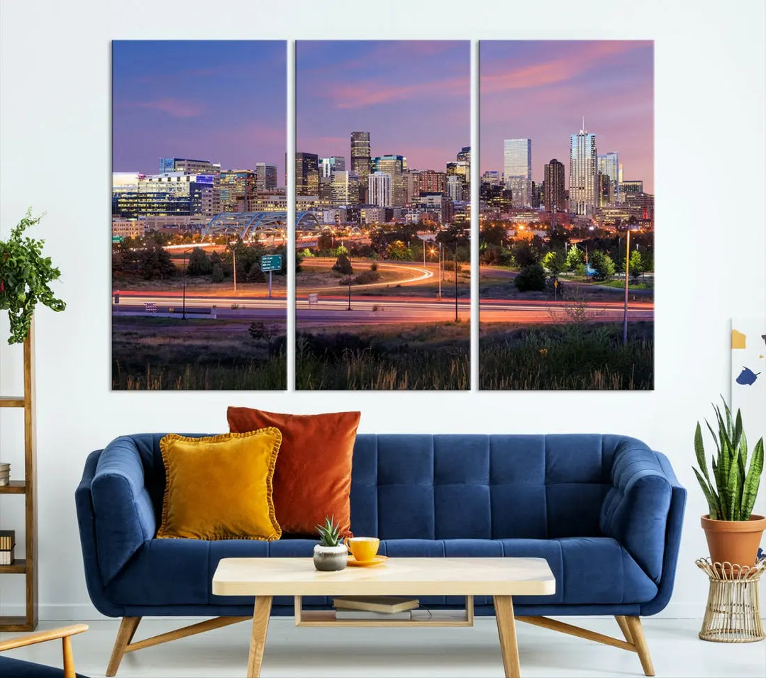 The Denver City Lights Sunset Purple Skyline Cityscape View Wall Art Canvas Print is crafted on museum-quality canvas with a UV-protective coating. It is displayed on a wall.