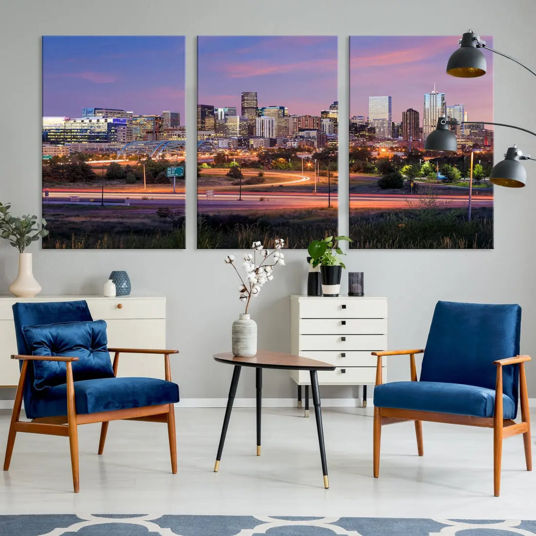 The Denver City Lights Sunset Purple Skyline Cityscape View Wall Art Canvas Print is crafted on museum-quality canvas with a UV-protective coating. It is displayed on a wall.