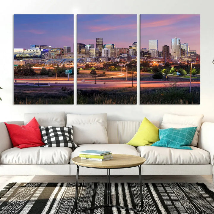 The Denver City Lights Sunset Purple Skyline Cityscape View Wall Art Canvas Print is crafted on museum-quality canvas with a UV-protective coating. It is displayed on a wall.