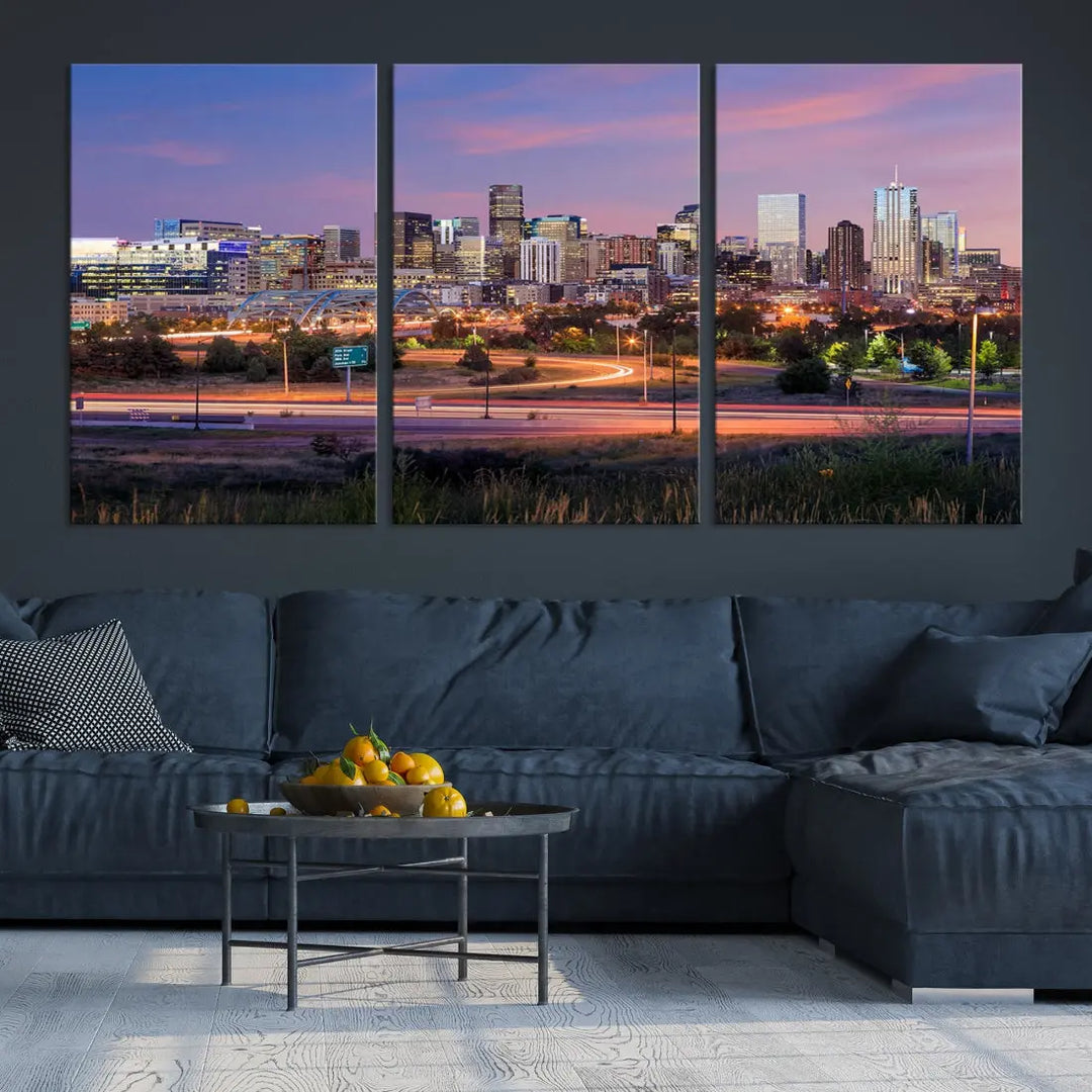 The Denver City Lights Sunset Purple Skyline Cityscape View Wall Art Canvas Print is crafted on museum-quality canvas with a UV-protective coating. It is displayed on a wall.