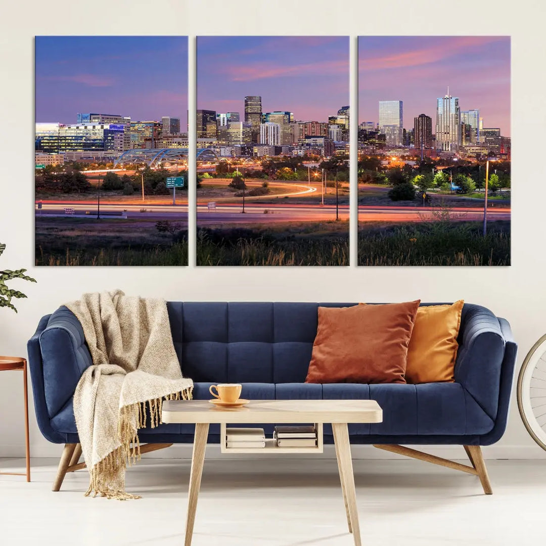 The Denver City Lights Sunset Purple Skyline Cityscape View Wall Art Canvas Print is crafted on museum-quality canvas with a UV-protective coating. It is displayed on a wall.