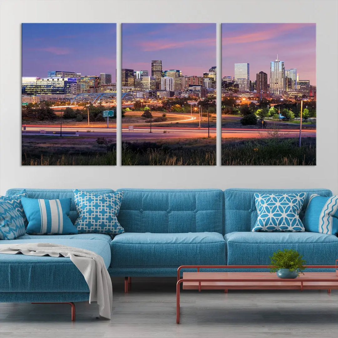 The Denver City Lights Sunset Purple Skyline Cityscape View Wall Art Canvas Print is crafted on museum-quality canvas with a UV-protective coating. It is displayed on a wall.