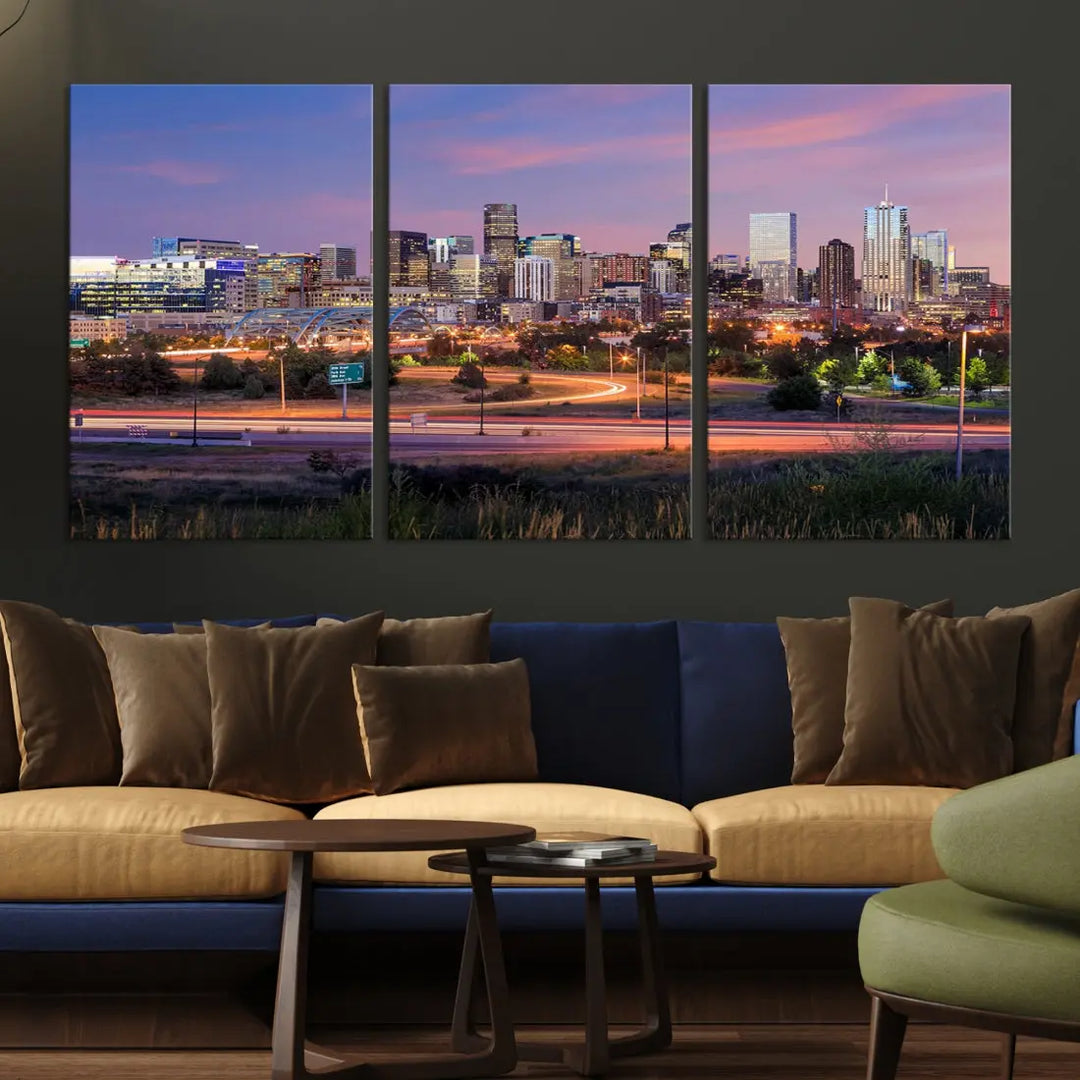 The Denver City Lights Sunset Purple Skyline Cityscape View Wall Art Canvas Print is crafted on museum-quality canvas with a UV-protective coating. It is displayed on a wall.