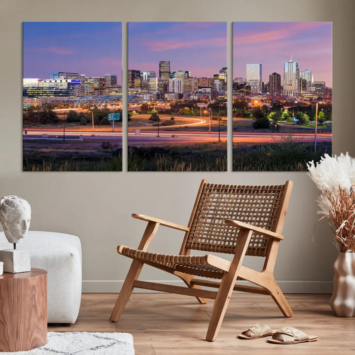 The Denver City Lights Sunset Purple Skyline Cityscape View Wall Art Canvas Print is crafted on museum-quality canvas with a UV-protective coating. It is displayed on a wall.