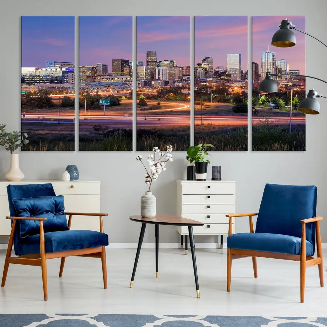 The Denver City Lights Sunset Purple Skyline Cityscape View Wall Art Canvas Print is crafted on museum-quality canvas with a UV-protective coating. It is displayed on a wall.