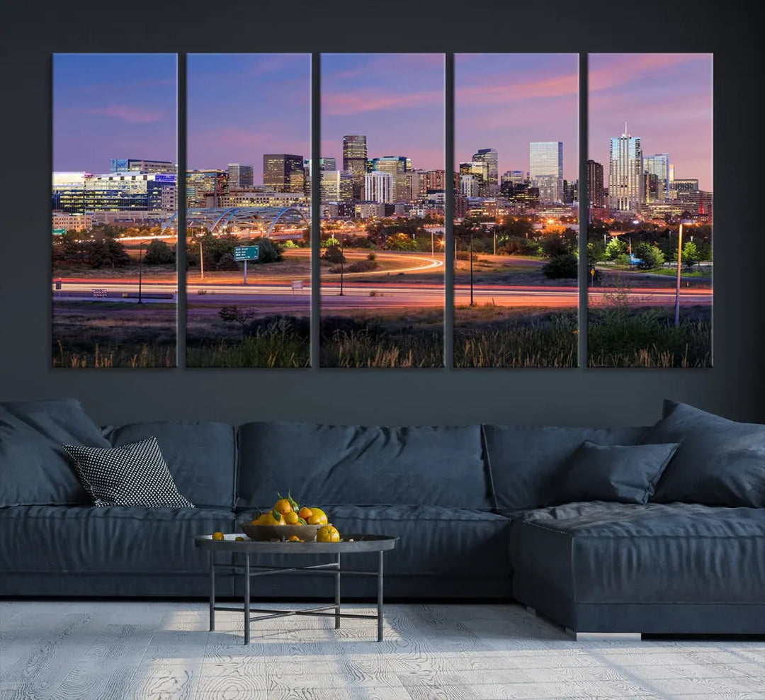 The Denver City Lights Sunset Purple Skyline Cityscape View Wall Art Canvas Print is crafted on museum-quality canvas with a UV-protective coating. It is displayed on a wall.