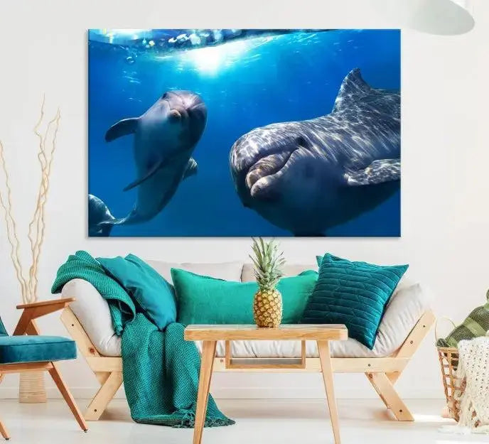 The Dolphin Wall Art Underwater Canvas Print showcases three panels of dolphins swimming underwater, gallery wrapped on museum-quality canvas with UV-protective coating.