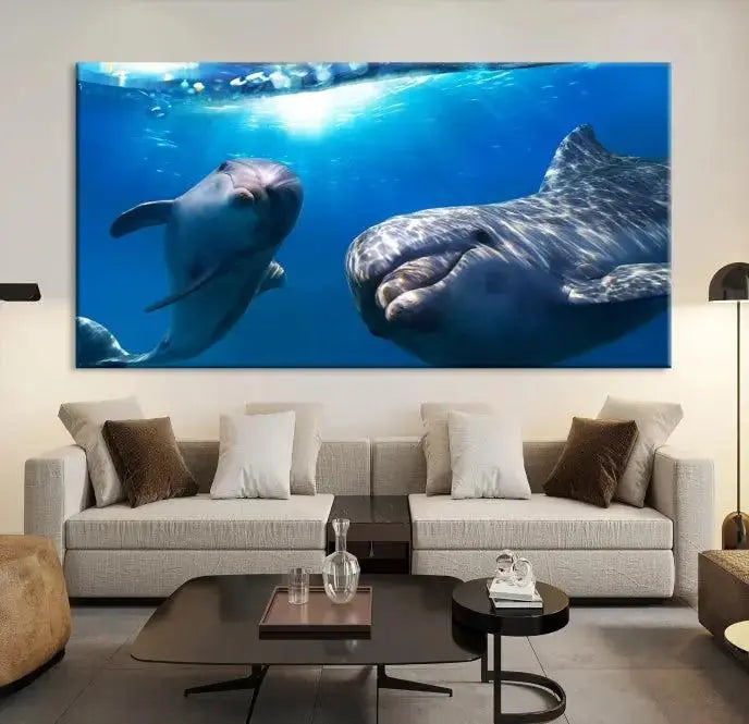 The Dolphin Wall Art Underwater Canvas Print showcases three panels of dolphins swimming underwater, gallery wrapped on museum-quality canvas with UV-protective coating.