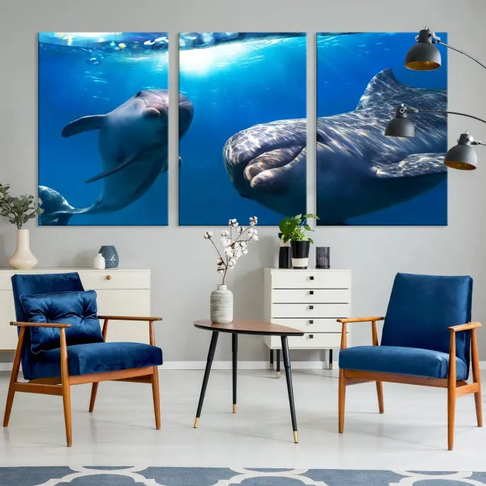 The Dolphin Wall Art Underwater Canvas Print showcases three panels of dolphins swimming underwater, gallery wrapped on museum-quality canvas with UV-protective coating.