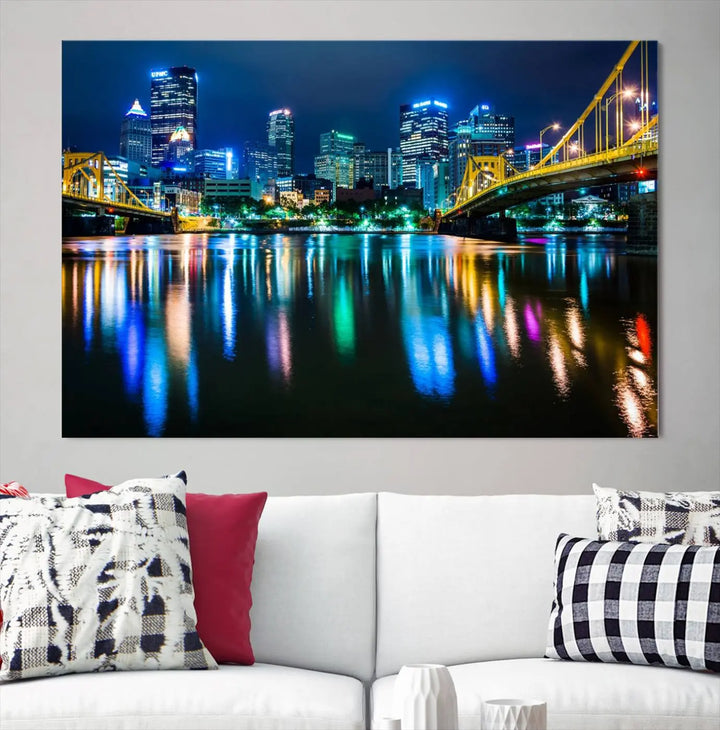 The "Downtown Pittsburgh at Night Canvas Wall Art" is a stunning museum-quality print that showcases the Pittsburgh skyline, reflecting over water and adorned with bright city lights.