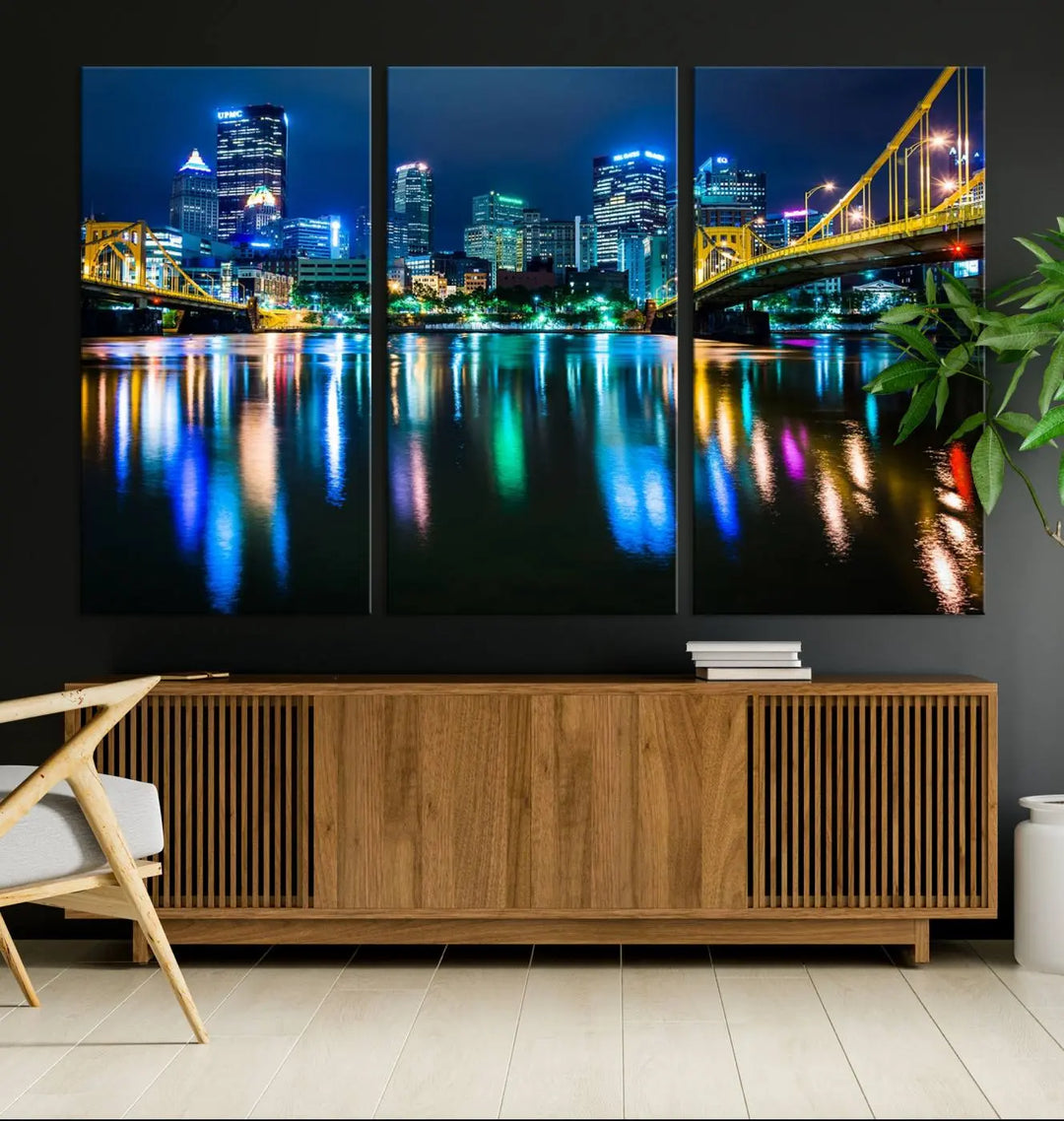 The "Downtown Pittsburgh at Night Canvas Wall Art" is a stunning museum-quality print that showcases the Pittsburgh skyline, reflecting over water and adorned with bright city lights.