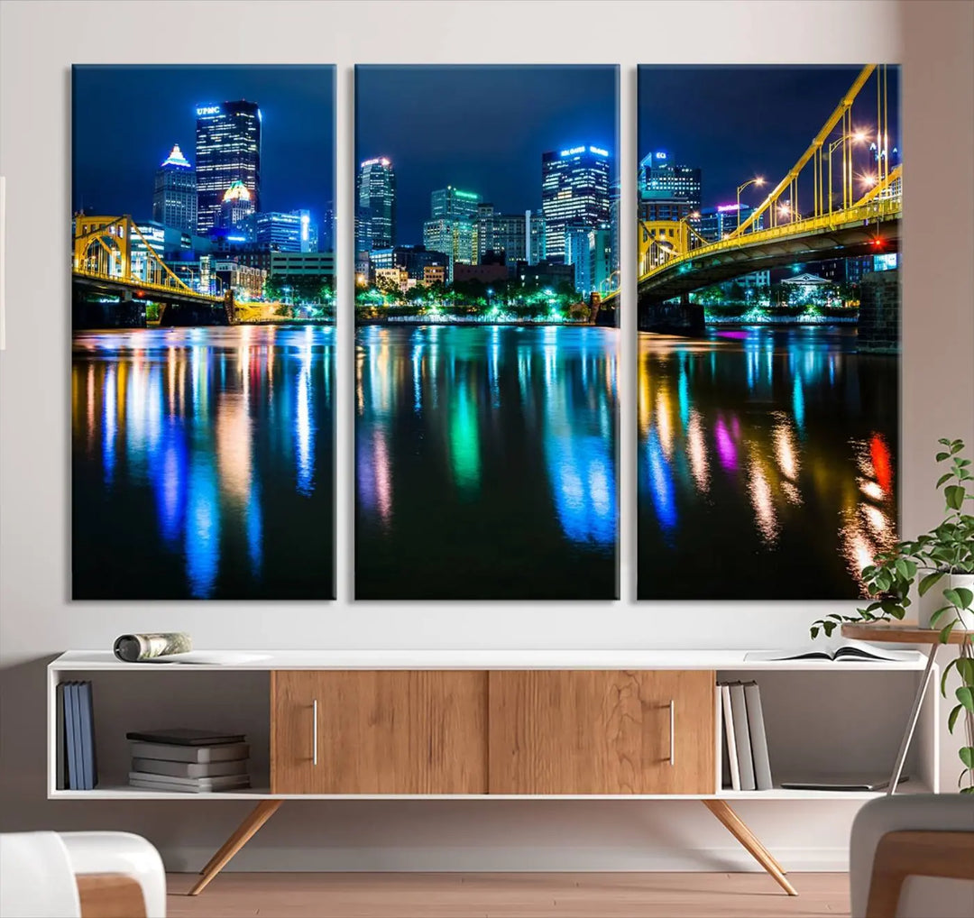 The "Downtown Pittsburgh at Night Canvas Wall Art" is a stunning museum-quality print that showcases the Pittsburgh skyline, reflecting over water and adorned with bright city lights.