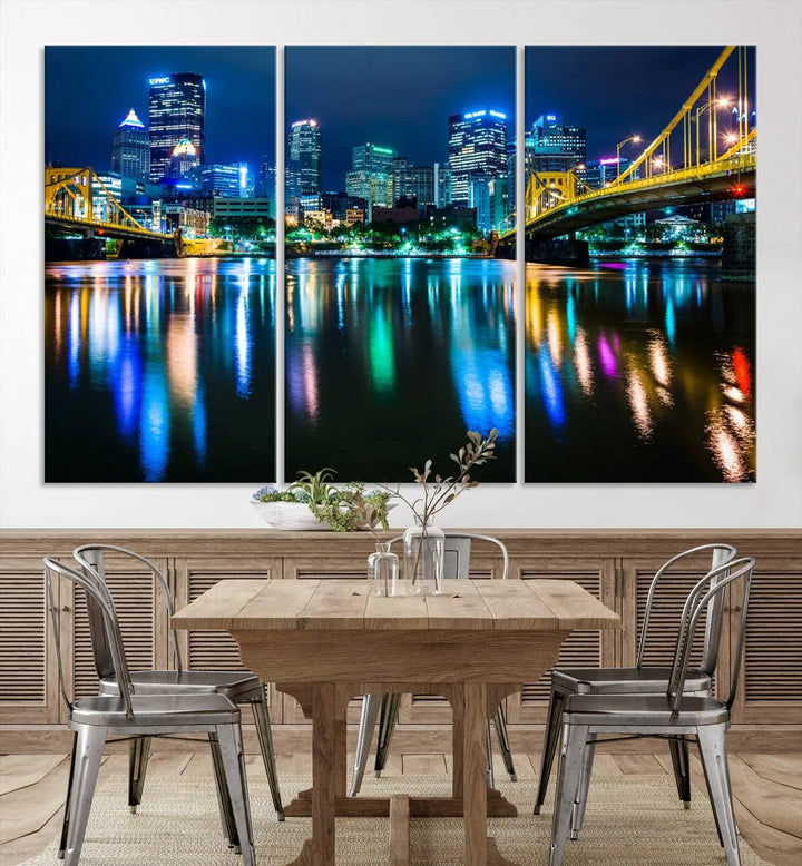 The "Downtown Pittsburgh at Night Canvas Wall Art" is a stunning museum-quality print that showcases the Pittsburgh skyline, reflecting over water and adorned with bright city lights.