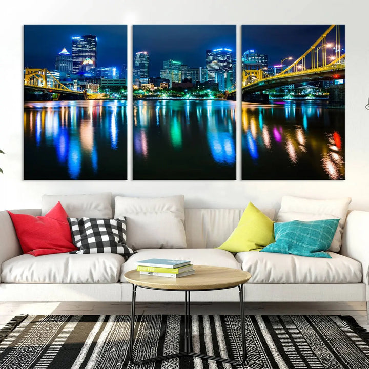 The "Downtown Pittsburgh at Night Canvas Wall Art" is a stunning museum-quality print that showcases the Pittsburgh skyline, reflecting over water and adorned with bright city lights.