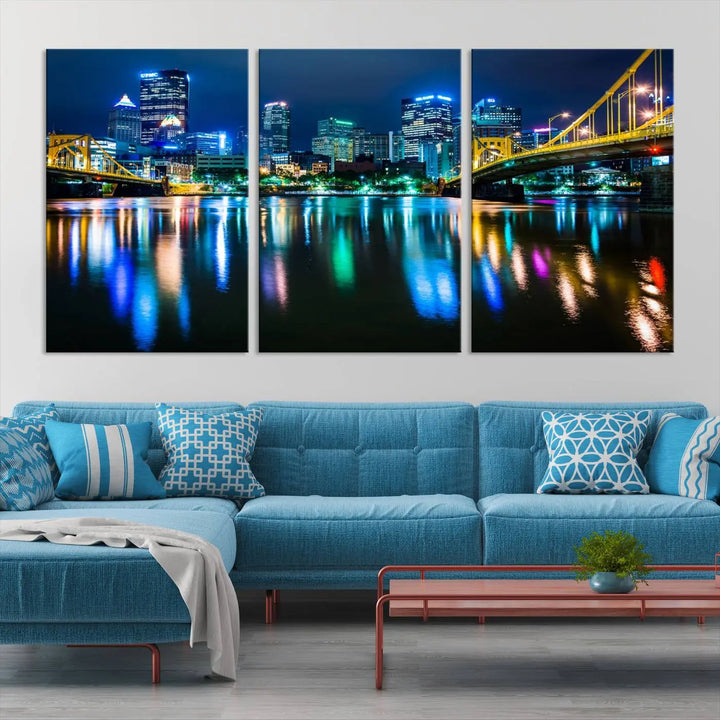 The "Downtown Pittsburgh at Night Canvas Wall Art" is a stunning museum-quality print that showcases the Pittsburgh skyline, reflecting over water and adorned with bright city lights.